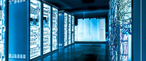 Servers in rows on metal shelves in dark cooling room