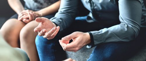 Couple counseling or therapy session. Man talking about problems in the family. Husband and wife meeting their psychiatrist.