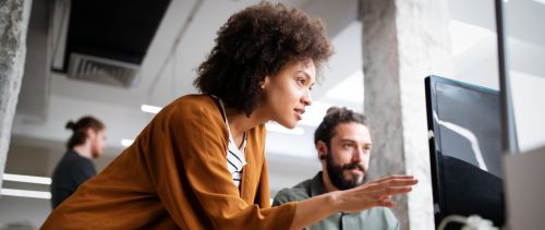 Programmers cooperating at IT company developing apps