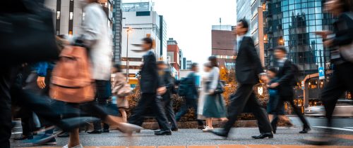 Blurred business people on their way from work