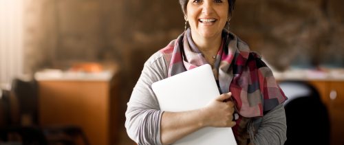 Adult student holding laptop