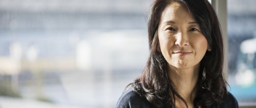 Businesswoman standing in the office of the window female leader woman asian
