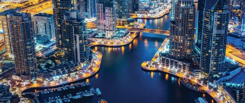 Illuminated architecture of Dubai by night. Scenic skyline.