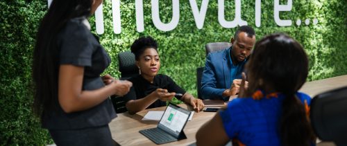 Young African businesswoman talking with colleagues in an office boardroom