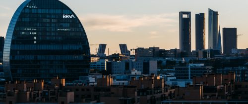 View of the skyline of Madrid with Las Tablas residential district, BBVA office building and Cuatro Torres financial district at sunset.