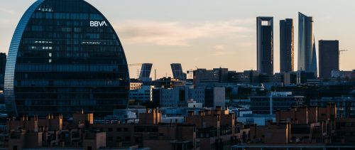 View of the skyline of Madrid with Las Tablas residential district, BBVA office building and Cuatro Torres financial district at sunset. View of the skyline of Madrid with Las Tablas residential district, BBVA office building and Cuatro Torres financial district at sunset.