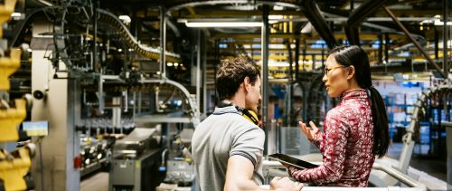 Mechanic And Female Engineer Talking in Factory