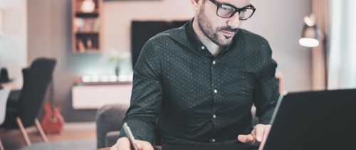 Worried businessman checking financial numbers