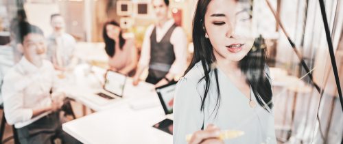 Asian Businesswoman presenting her ideas for company development