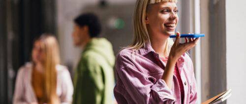 Young Woman Engaging with Voice Assistant on Smartphone