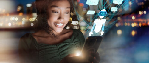 Beautiful curly woman of color interacts with smart phone with futuristic transparent screen displaying chatbot and text clouds, symbolizing artificial intlellingence, advanced technology and innovation